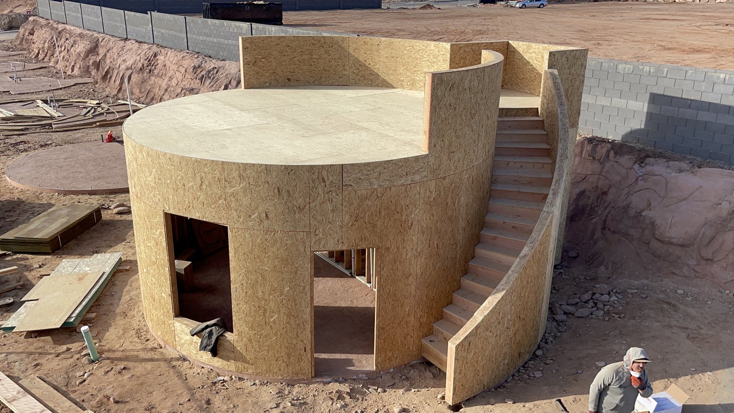 Elevated view of sheathed curved kiva structures