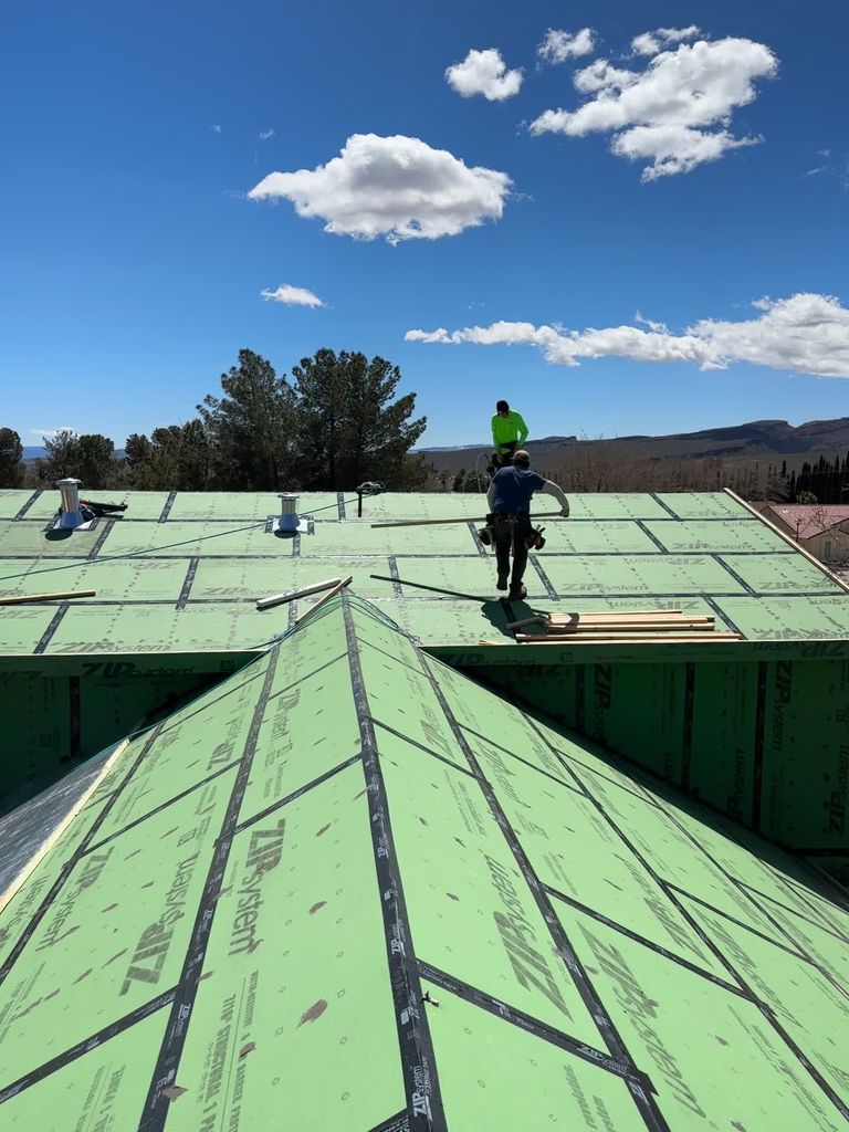 Proud Hammer Homes crew installing green ZIP System sheathing on a two-story roof