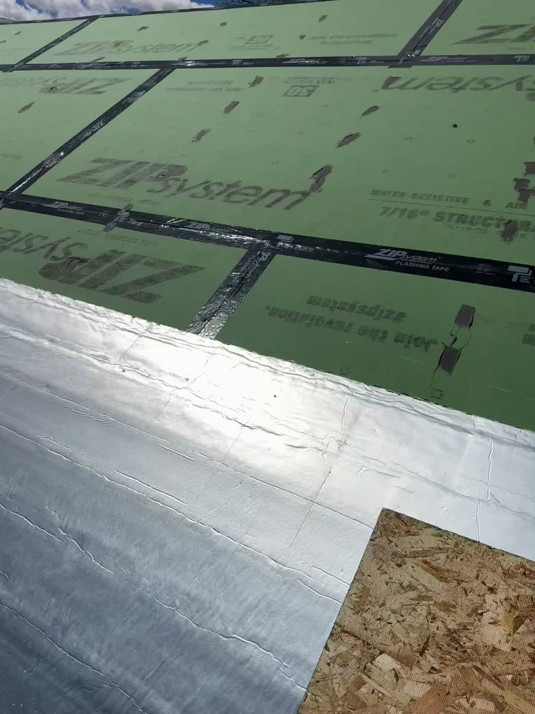 Radiant aluminum barrier being installed over the insulated green roof assembly